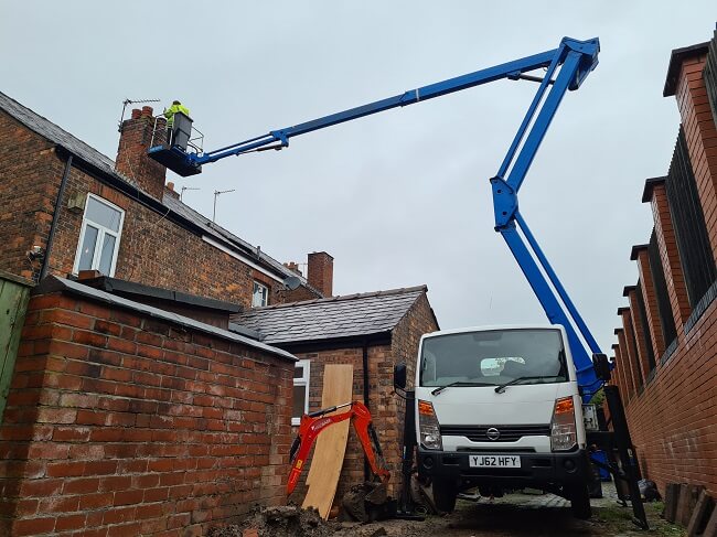 image of cherry picker in tight alley